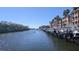 Scenic water view with boat docks, surrounded by condominium buildings and lush trees under a sunny sky at 5000 Culbreath Key Way # 1-220, Tampa, FL 33611