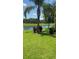 Lush backyard featuring manicured lawn and a serene view of the water at 5103 Shady Stone Pl, Wimauma, FL 33598