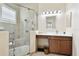 Accessible bathroom featuring a large glass shower, grab bars, neutral tile, and modern sink vanity at 5103 Shady Stone Pl, Wimauma, FL 33598