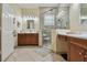 Accessible bathroom featuring a large glass enclosed shower, neutral tile, and dual sink vanity at 5103 Shady Stone Pl, Wimauma, FL 33598