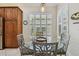 Bright breakfast nook with a glass table, shuttered windows, and views of the kitchen's features at 5103 Shady Stone Pl, Wimauma, FL 33598