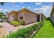 Home exterior with well-manicured lawn and landscaping, and brick paver walkway at 5103 Shady Stone Pl, Wimauma, FL 33598