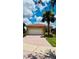 Inviting single-story house with a paver driveway, two-car garage, and manicured front yard at 5103 Shady Stone Pl, Wimauma, FL 33598