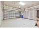 A spacious two car garage with epoxy floors and cabinets for storage at 5103 Shady Stone Pl, Wimauma, FL 33598