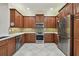 Well-equipped kitchen featuring stainless steel appliances, stylish cabinetry, and mosaic tile backsplash at 5103 Shady Stone Pl, Wimauma, FL 33598