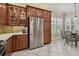 Modern kitchen with stainless steel appliances, mosaic backsplash, and tile flooring at 5103 Shady Stone Pl, Wimauma, FL 33598