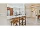 Open kitchen with white countertops, breakfast bar, stainless appliances, and tile flooring at 5103 Shady Stone Pl, Wimauma, FL 33598