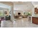Open-concept living area with tile floors, a dining area, and a living room featuring sliding glass doors at 5103 Shady Stone Pl, Wimauma, FL 33598