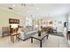 Bright living room featuring neutral tones, tile floors, and an open floor plan at 5103 Shady Stone Pl, Wimauma, FL 33598
