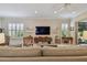 Living room featuring a large flat-screen TV and comfortable seating arrangements at 5103 Shady Stone Pl, Wimauma, FL 33598