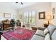 Bright office with a decorative rug, shuttered window, and a couch at 5103 Shady Stone Pl, Wimauma, FL 33598