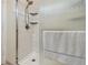 Walk-in shower features subway tile surround, a mounted shower head, and glass doors at 5103 Shady Stone Pl, Wimauma, FL 33598
