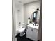 Bathroom featuring modern vanity, round mirror, black hardware, and a tiled shower/tub combo at 5423 Sweetwater Terrace Cir, Tampa, FL 33634