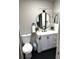 Bathroom showcasing modern vanity, round mirror, black hardware, and tile flooring at 5423 Sweetwater Terrace Cir, Tampa, FL 33634