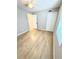 A bedroom featuring hardwood floors, white trim, and a bright window at 5423 Sweetwater Terrace Cir, Tampa, FL 33634