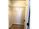 Empty closet with wood-look flooring, wire shelving, and a rod at 5423 Sweetwater Terrace Cir, Tampa, FL 33634