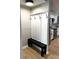 Charming entryway with a stylish coat rack, storage bench, and view into the modern kitchen at 5423 Sweetwater Terrace Cir, Tampa, FL 33634