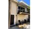Welcoming townhouse entrance features a cozy outdoor seating area and balcony above at 5423 Sweetwater Terrace Cir, Tampa, FL 33634