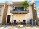 Townhouse front exterior featuring a cozy outdoor seating area and second story balcony at 5423 Sweetwater Terrace Cir, Tampa, FL 33634