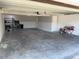 Spacious, clean garage featuring white walls, ample lighting, and durable concrete flooring at 5423 Sweetwater Terrace Cir, Tampa, FL 33634