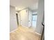 Hallway featuring wood flooring, neutral paint, and doors to various rooms at 5423 Sweetwater Terrace Cir, Tampa, FL 33634
