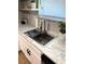 Stainless steel kitchen sink featuring modern faucet and marble countertop at 5423 Sweetwater Terrace Cir, Tampa, FL 33634