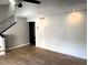 Neutral painted living room with stairs and wood laminate flooring at 5423 Sweetwater Terrace Cir, Tampa, FL 33634