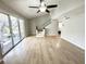 Bright living room with wood floors, stairs, and balcony access at 5423 Sweetwater Terrace Cir, Tampa, FL 33634