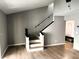 Bright living room with wood flooring, staircase, and modern lighting at 5423 Sweetwater Terrace Cir, Tampa, FL 33634