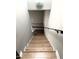 View of a staircase featuring wood treads, white risers, and a black handrail at 5423 Sweetwater Terrace Cir, Tampa, FL 33634