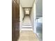 Inviting stairwell featuring modern flooring, neutral walls, and access to the upper level at 5423 Sweetwater Terrace Cir, Tampa, FL 33634