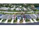 Aerial shot captures a two-story residence with dark roof, verdant lawn, and landscaped gardens in a neighborhood setting at 5546 Spanish Moss Cv, Bradenton, FL 34203
