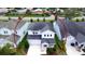 Aerial view of a two-story home featuring a well-manicured lawn, neutral-toned exterior, and landscaped surroundings at 5546 Spanish Moss Cv, Bradenton, FL 34203