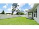 Backyard featuring a well-maintained lawn, a privacy fence, and a covered patio, ideal for outdoor living at 5546 Spanish Moss Cv, Bradenton, FL 34203