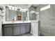 Modern bathroom with gray cabinets, double sinks, large shower, and stylish fixtures at 5546 Spanish Moss Cv, Bradenton, FL 34203