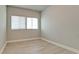 Spare bedroom with laminate flooring, base trim and a sunny window with blinds at 5546 Spanish Moss Cv, Bradenton, FL 34203