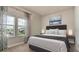 Cozy bedroom with a plush bed, decorative art, and soft natural lighting from large windows at 5546 Spanish Moss Cv, Bradenton, FL 34203