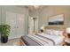 Well-lit bedroom with modern lighting, plush bedding, and double closets offers comfort at 5546 Spanish Moss Cv, Bradenton, FL 34203