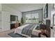 Cozy bedroom with a large window, a dresser, and neutral tones at 5546 Spanish Moss Cv, Bradenton, FL 34203