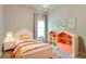 Charming bedroom with a colorful bed, playful decor, and ample toy storage at 5546 Spanish Moss Cv, Bradenton, FL 34203