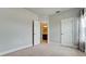 View of the bedroom showcasing an ensuite bathroom and closet doors at 5546 Spanish Moss Cv, Bradenton, FL 34203