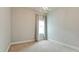Bright bedroom featuring neutral walls, carpet, stylish light fixture, and large window with soft, flowing curtains at 5546 Spanish Moss Cv, Bradenton, FL 34203