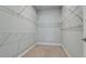 Walk-in closet with custom shelving and carpeted floor ready for easy organization at 5546 Spanish Moss Cv, Bradenton, FL 34203