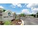 A gated entrance to Moss Creek welcomes residents with a stone sign and landscaped surroundings at 5546 Spanish Moss Cv, Bradenton, FL 34203