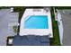 Overhead view of a community pool featuring lounge chairs, tables, and well-maintained surroundings at 5546 Spanish Moss Cv, Bradenton, FL 34203