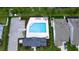 Aerial view of a community pool, showing lounge chairs, a parking lot, and nearby buildings at 5546 Spanish Moss Cv, Bradenton, FL 34203