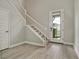 Entryway with light wood-look floors, staircase with white railings, and plenty of natural light at 5546 Spanish Moss Cv, Bradenton, FL 34203