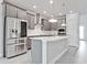 Modern kitchen featuring stainless steel appliances, gray cabinets, and a quartz countertop island at 5546 Spanish Moss Cv, Bradenton, FL 34203