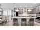Contemporary kitchen boasts stainless appliances, pendant lighting, and an island with seating at 5546 Spanish Moss Cv, Bradenton, FL 34203