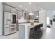 Modern kitchen with gray cabinetry, stainless steel appliances, and a kitchen island with bar stool seating at 5546 Spanish Moss Cv, Bradenton, FL 34203